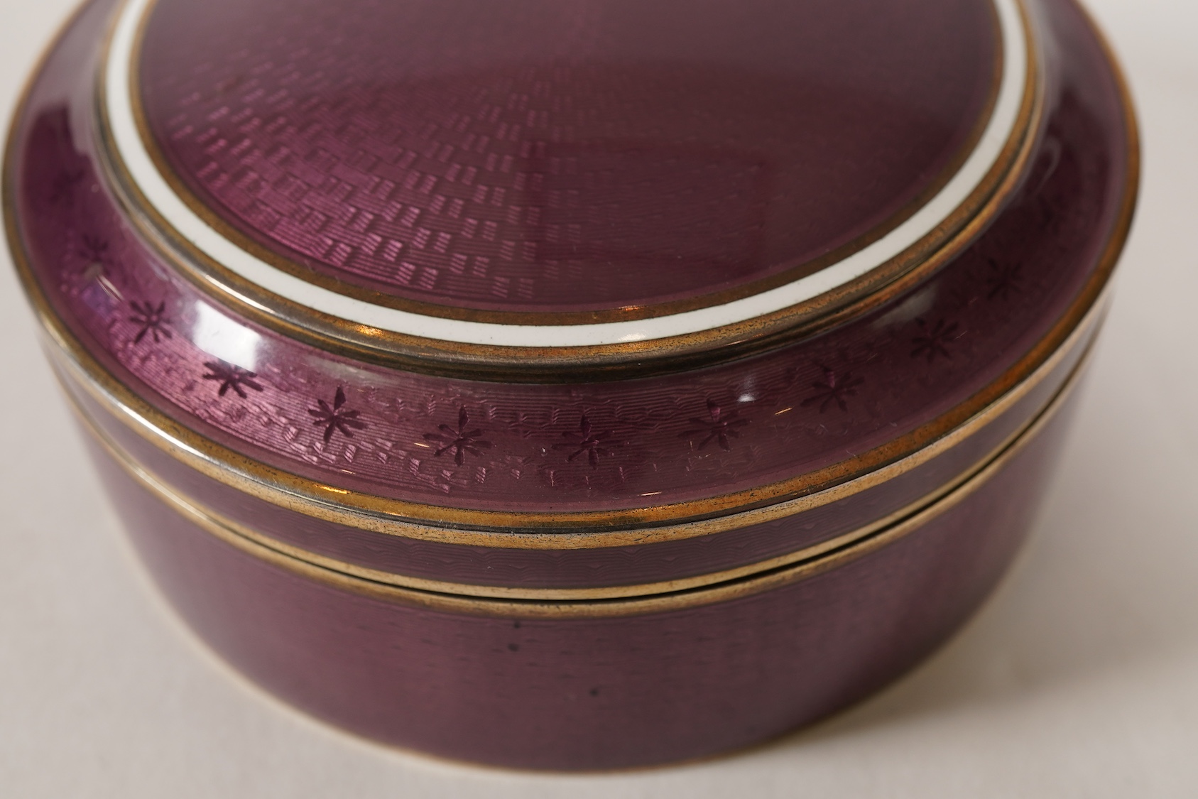 A late 19th/early 20th century North American sterling and mauve guilloche enamel circular box and cover, by Theodore B. Starr Inc, New York
